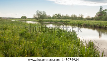 River curve in a Dutch rural landscape in the spring season.