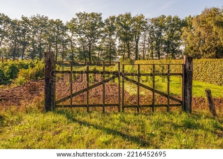 Similar – Image, Stock Photo Wooden gate between two houses with no trespassing sign.