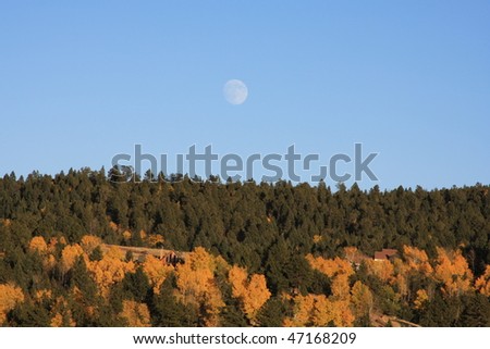 Autumn full moon over mountain in Colorado