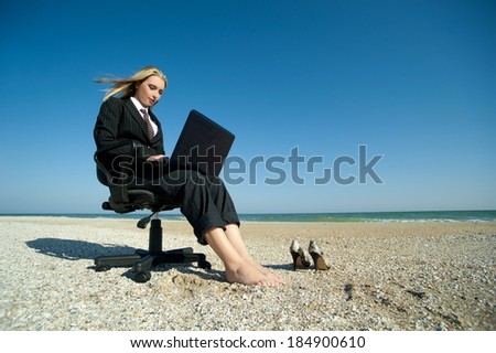 Concept illustrating remote work, business woman with laptop and office chair on the beach