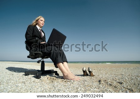 Concept illustrating remote work, business woman with laptop and office chair on the beach