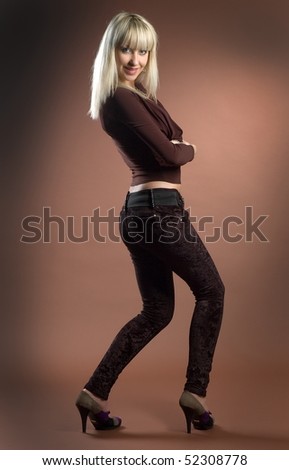 Beautiful sexual high-heeled girl on brown background