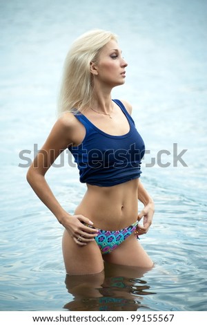 sexy blonde woman in water wearing bikini