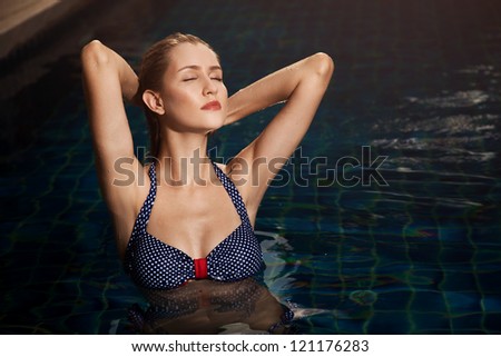 Young woman beauty portrait in swimming pool