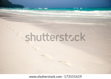 White beach, azure sea, waves and footsteps on perfect snow-white sand.