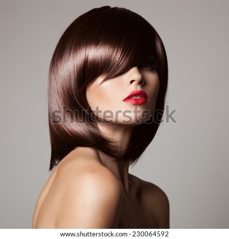 Beauty model with perfect long glossy brown hair. Close-up portrait.