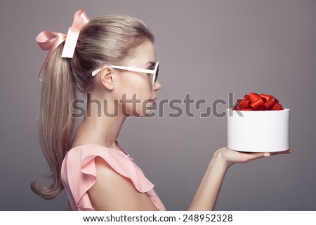 Young woman with a gift in hand.