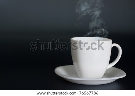 white cup with hot liquid and steam