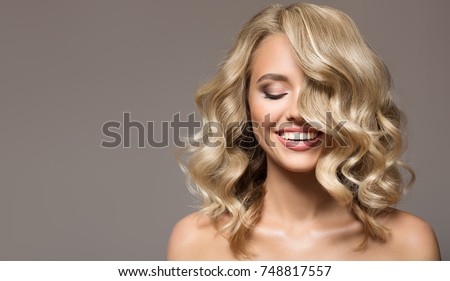 Blonde woman with curly beautiful hair smiling on gray background.  Stock fotó © 