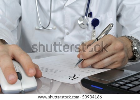 Doctor making prescription working with computer