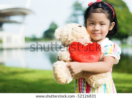 cute girl hug a teddy bear