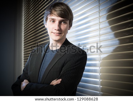 young business man in a dark office