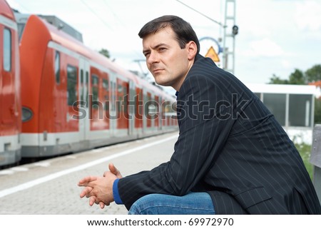Business man waiting for a train