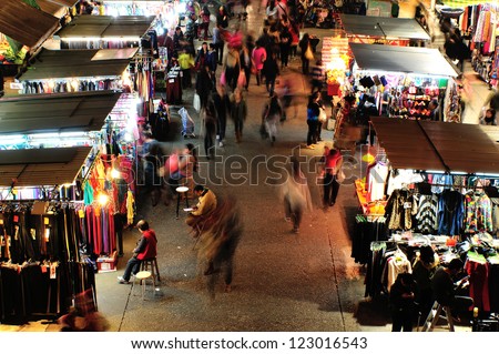 HONG KONG, CHINA - DEC 25: Crowded people walk through the market on December 25, 2012 in Mong Kok, Hong Kong. Mong Kok, Hong Kong is the highest population density place in the world.
