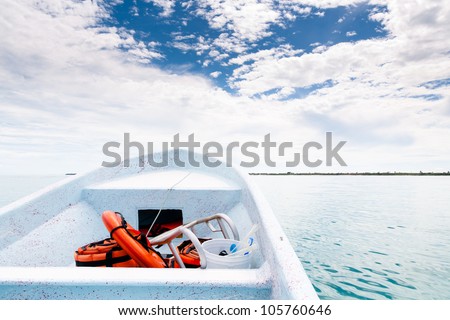 White boat sailing in open sea to the land at caribbean sea