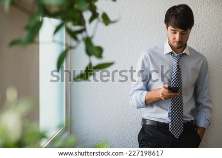 Young business man looking at phone