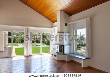 room with terracotta floor,windows overlooking the garden