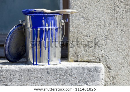 bucket and paint to paint the walls of the house