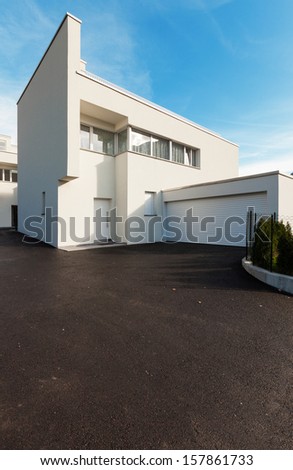 modern house white with garage , view from the courtyard