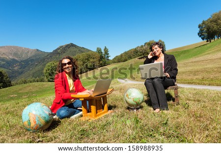 two business women in the countryside, outdoors