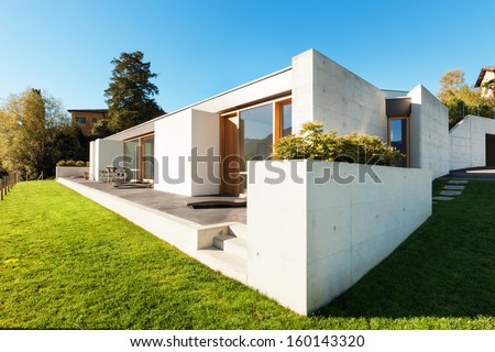 beautiful modern house in cement, view from the garden