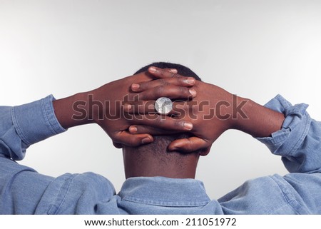 African man with arms crossed behind his back, concept