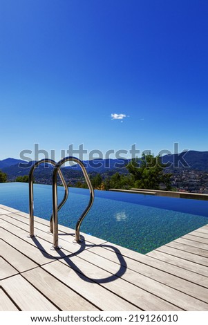 Grab bars ladder in the swimming pool, outdoor