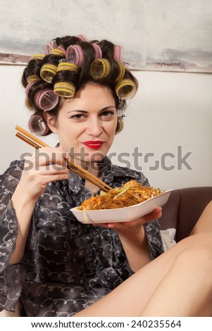 portrait of a girl with food takeaway, sitting on the sofa