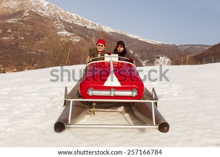 Elderly couple on a pedalo in the snow