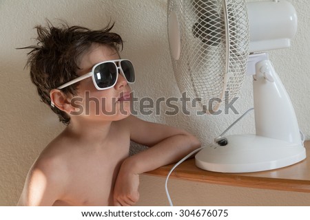 boy cools with a fan, portrait