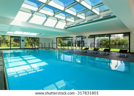 indoor swimming pool of a modern house with spa