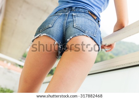Young girl in hot pants very sexy, posing on the balcony