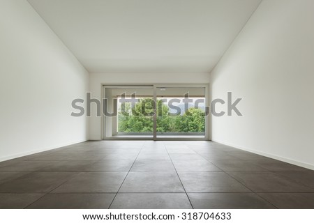 interior of new apartment, wide room with window, tiled  floor