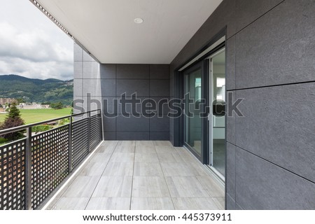 Similar – Image, Stock Photo An empty balcony and a closed shutter above it, plus a railing that no longer protects anyone