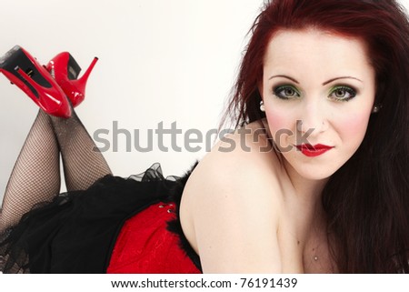portrait of a red-haired female model on white background