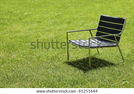Design chair isolated on the lawn outdoors