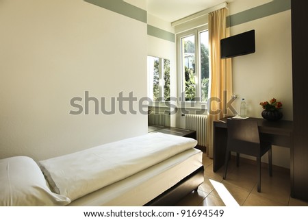 simple hotel room, single bed