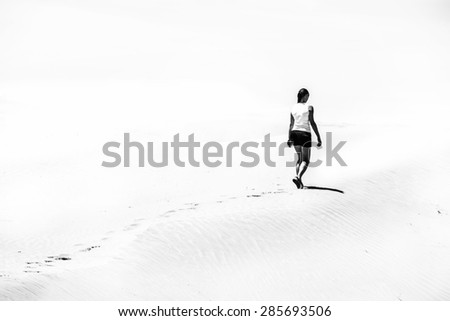Woman walking on the desert Black and white photo