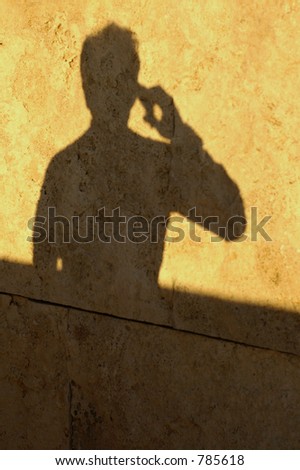 Shadow of a man talking on the phone