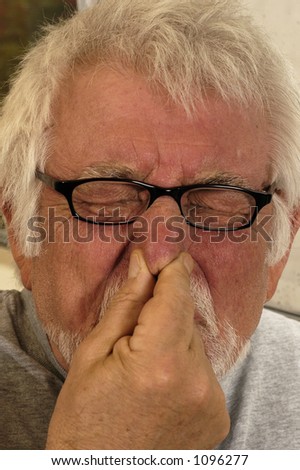 Man holding nose because of bad smell