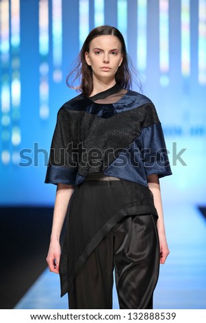 ZAGREB, CROATIA - MARCH 15: Fashion model on catwalk wearing clothes designed by Zona45 Young Sqaut on the \'Fashion.hr\' show on March 15, 2013 in Zagreb, Croatia.