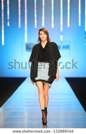 ZAGREB, CROATIA - MARCH 15: Fashion model on catwalk wearing clothes designed by Zona45 Young Sqaut on the \'Fashion.hr\' show on March 15, 2013 in Zagreb, Croatia.