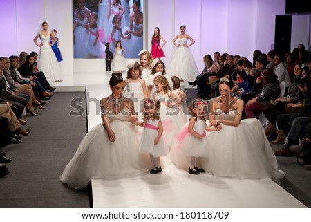 ZAGREB, CROATIA - FEBRUARY 15, 2014: Fashion models in wedding dresses with children models dressed as little bridesmaid on \'Wedding fair\'