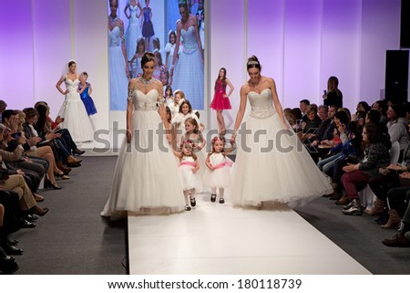 ZAGREB, CROATIA - FEBRUARY 15, 2014: Fashion models in wedding dresses with children models dressed as little bridesmaid on \'Wedding fair\'