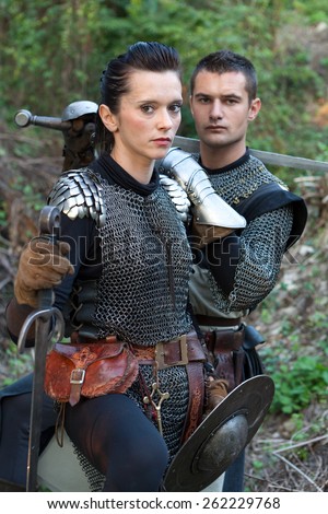 ZAGREB, CROATIA - OCTOBER 07, 2012: Woman and a man dressed in medieval clothes with swords, posing after the 