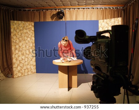 Improvised TV studio with blue background and a TV camera