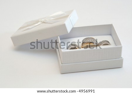 Golden ring and earrings in a white gift box