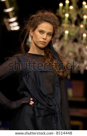 Fashion model posing under a runway lights