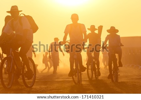 Golden sunset with many people