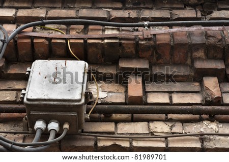 old brick wall with electrical boxes